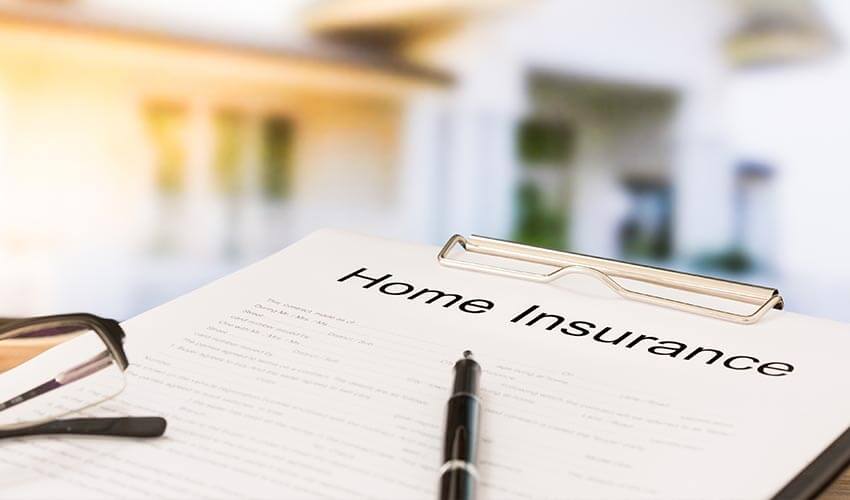 A clipboard containing a home insurance document