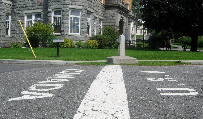 U.S. Canada border line drawn on the pavement.