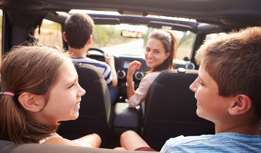Parents talking to children in the car.