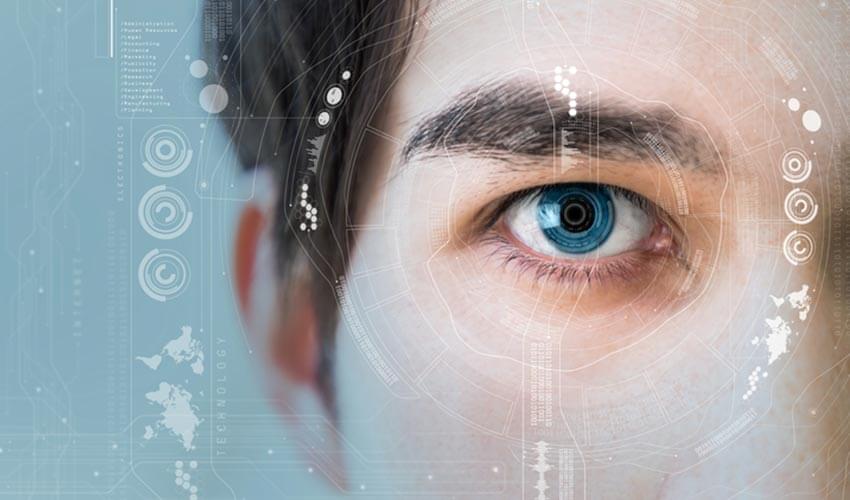 A close up of a man's face with icons and graphics symbolizing facial recognition.