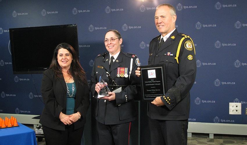 CAA presenting an award to Police Chief William Blair and Constable Jill Miller at the Toronto Police Headquarters