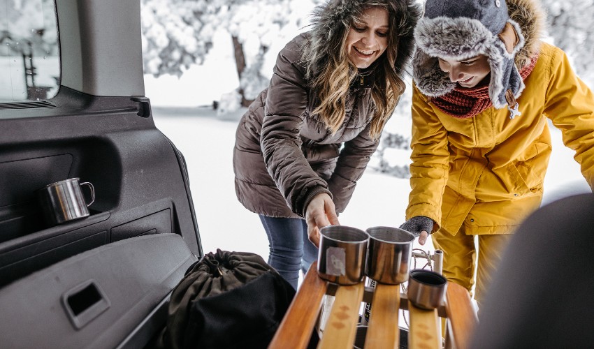 Women dressed for winter enjoying hot beverages.