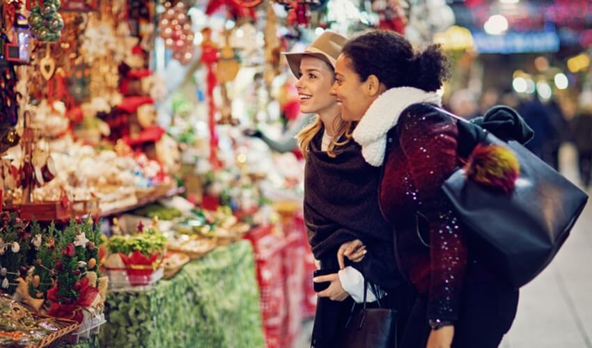 Two ladies shopping at a Christmas market.
