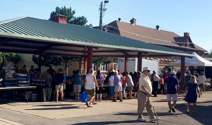 People walking around Welland Farmers’ Market.