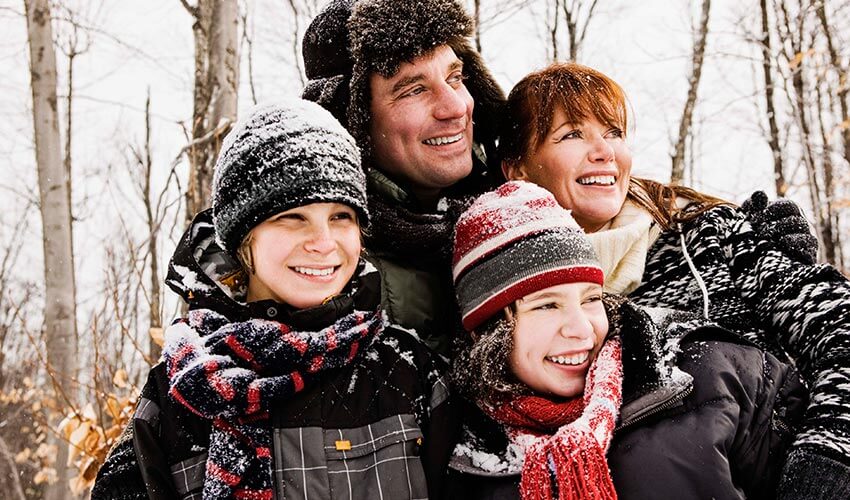 A family of four enjoying the outdoors in winter.