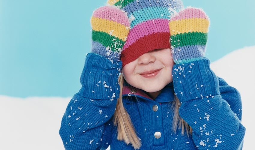 A young girl in colourful winter attire.