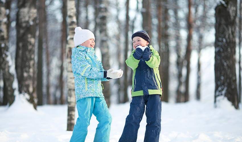 Two kids playing in the snow.
