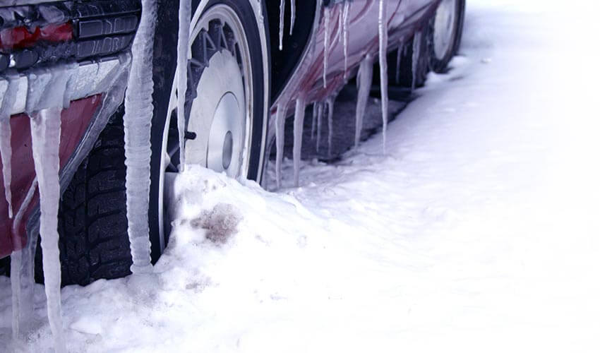 A close up of a car covered with ice in winter.