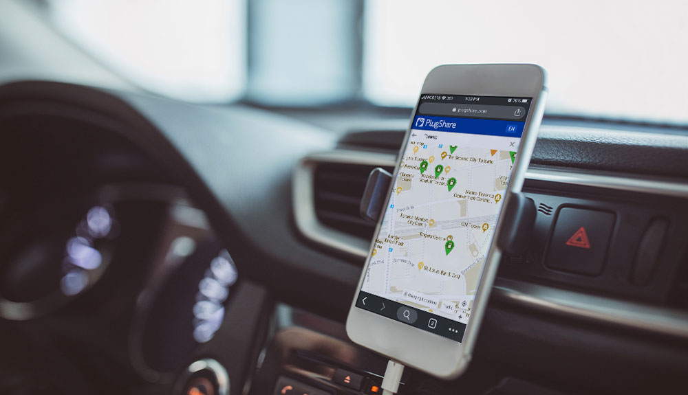 A map showing charging station locations is shown on a smartphone