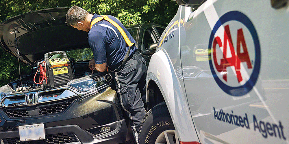 A CAA battery expert gets under the hood of a car to do some testing