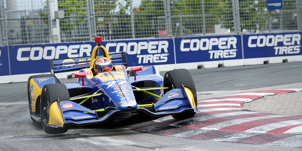 A race car speeds around the track at the Honda Indy Toronto.