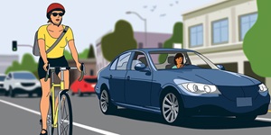 An illustration shows a cyclist riding on a busy road