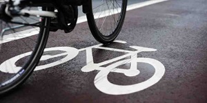 A bike cycles over a symbol marking a bike lane