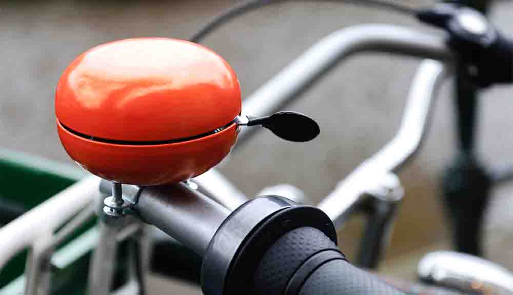 A red bicycle bell is shown