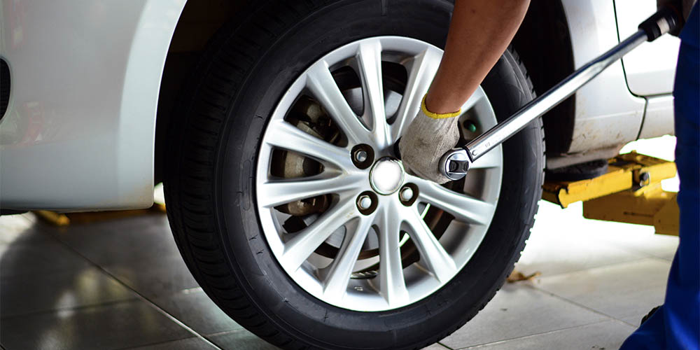 Bolts on a wheel are tightened to prevent separation.