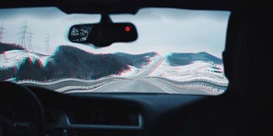 The view through a car windshield is distorted to mimic the experience of an impaired driver