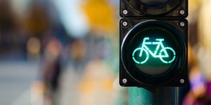 A traffic signal shows a green light shaped like a bicycle