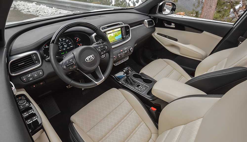 Interior shot of front seat with view of steering wheel and digital dashboard