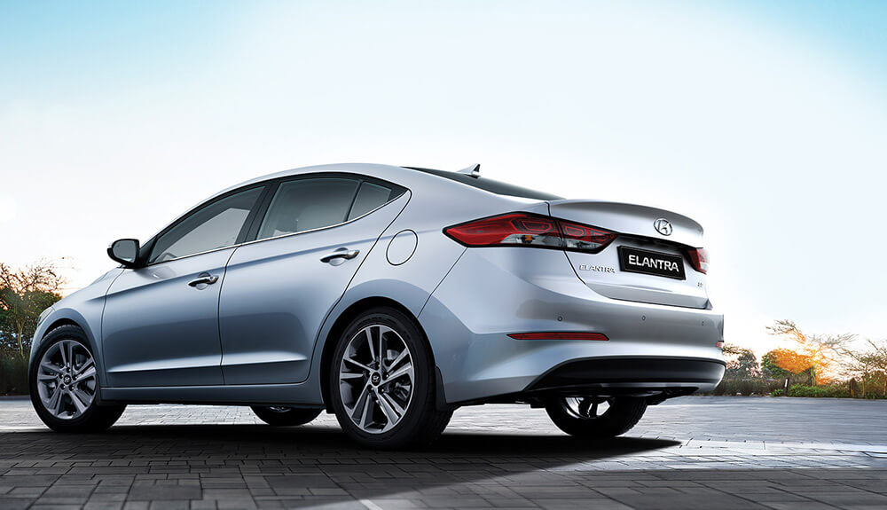 Silver Hyundai Elantra parked outside on gray interlocking brick