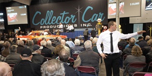 Taking bids from crowd at classic car auction
