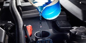 Pouring antifreeze into reservoir