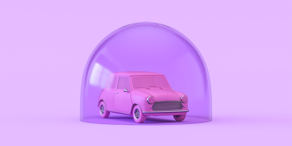 A small bubble pink toy car is sitting in a transparent purple dome. The background is a pastel purple.
