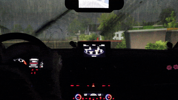 Woman drives test vehicle in a simulated rain storm at night