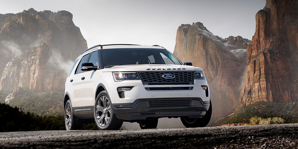 White 2018 Ford Explorer looking tough and sporty while parked in front of jagged cliffside