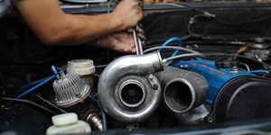 Closeup shot of person fixing the engine of a car