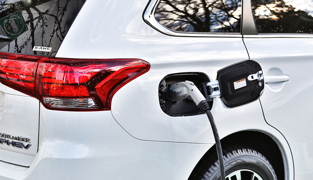 White 2018 Mitsubishi Outlander PHEV hybrid SUV being charged