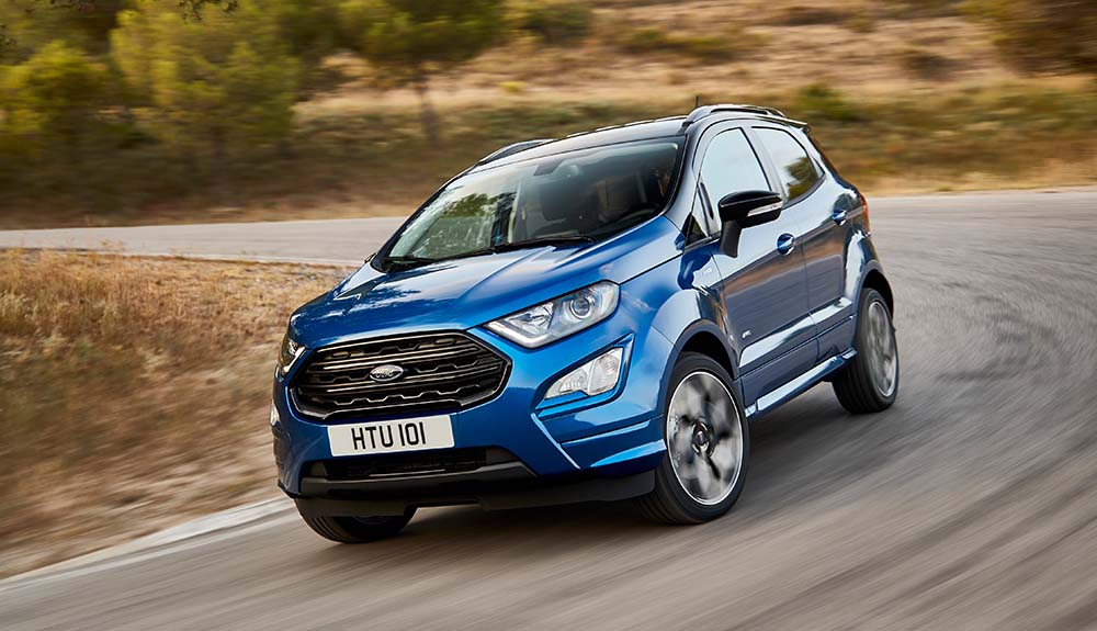 Dark blue Ford EcoSport crossover sedan speeding down freeway
