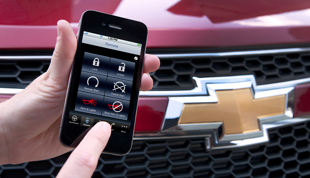 A cellphone shows the features of the myCadillac app on its screen