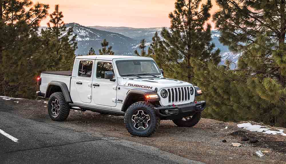 Jeep Gladiator pickup truck in rugged forest setting