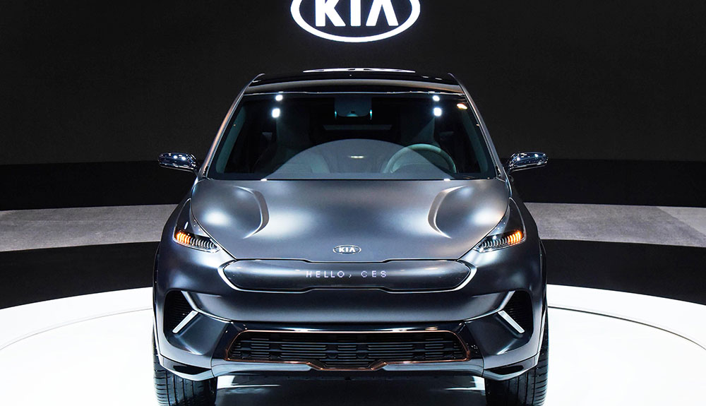 Front-on shot of Black Kia Niro EV concept electric SUV in Kia showroom, with logo lit up behind vehicle