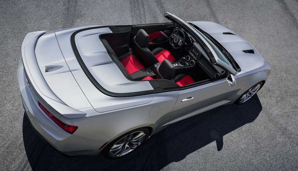 Birdseye view of a gorgeous silver convertible with black and red interiors