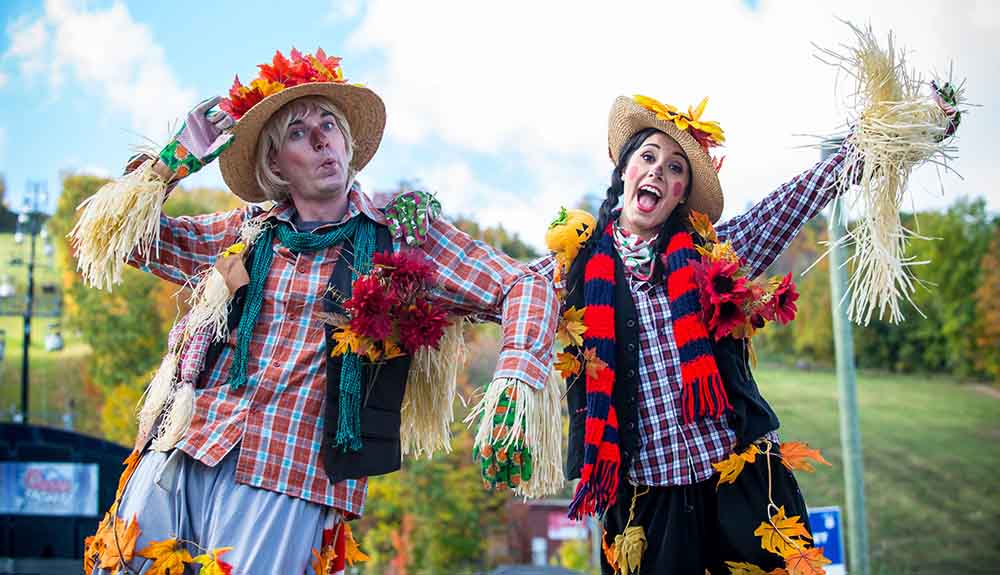 Man and woman dressed as scarecrows