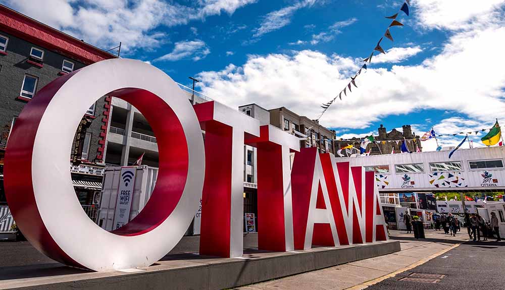 Large red and white Ottawa sign in Ottawa, Ontario as seen on a beautiful sunny Canada Day