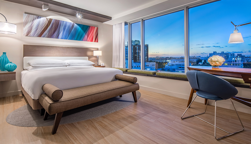 A chic hotel room at the Hyatt Centric South Beach hotel, the view looking out at the Florida skyline at night