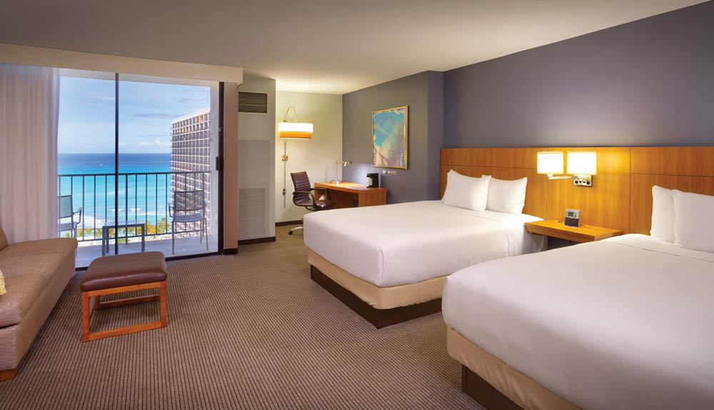 The simple and clean interior of a hotel room with double beds at the Hyatt Place Waikiki Beach, Oahu