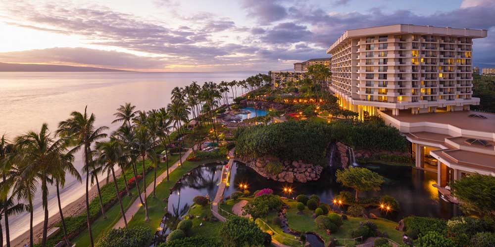 Overhead shot at a beautiful Hawaiin hotel resort with multiple pools, steps away from the beach