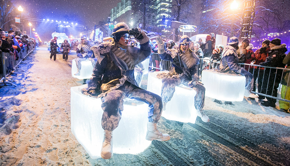 People in costumes sitting on blocks of ice at Quebec's Winter Festival