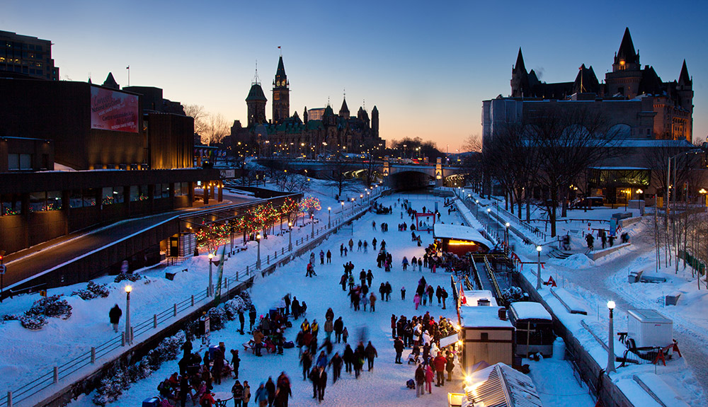 Lots of people walking around Winterlude in Ottawa as the sun goes down
