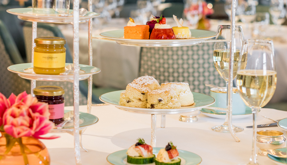 Jams, scones, wine glasses and other adorable tea party treats on table