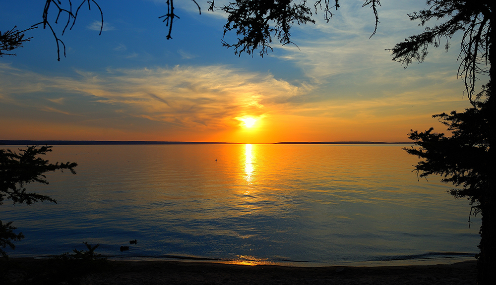 The sun is setting over Waskesiu Lake in Prince Albert National Park