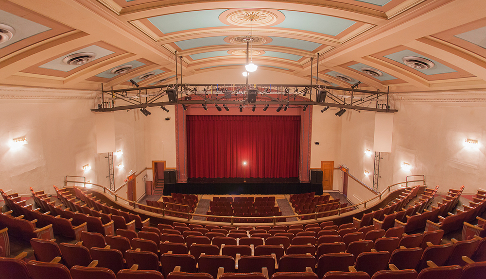 A view of empty audience seats and the stage of the Orillia Opera House