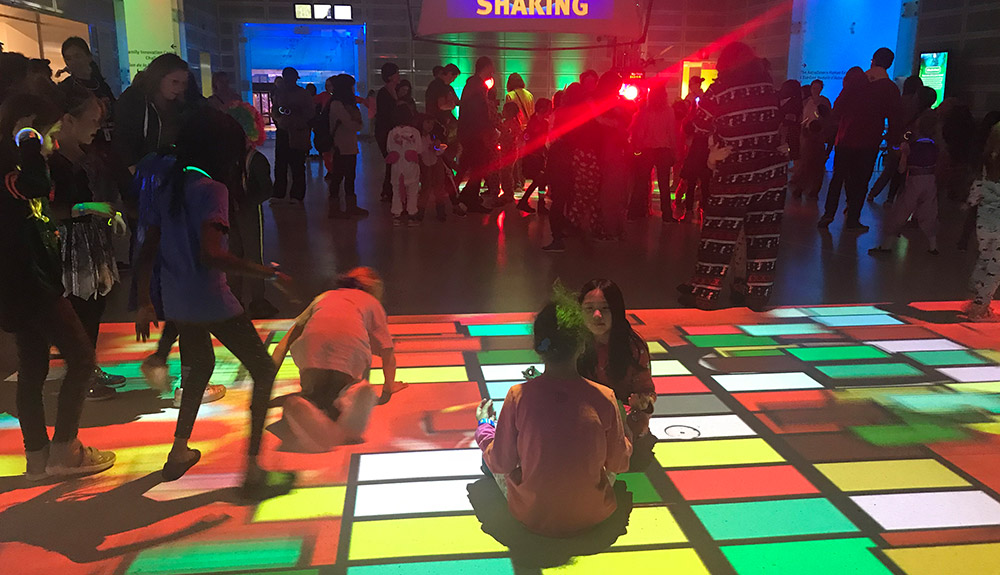 Kids play on a multi-coloured floor at the Ontario Science Centre