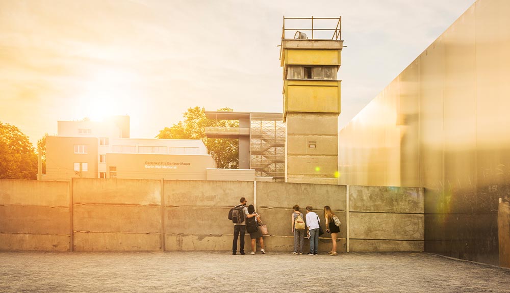 Visitors look at a section of the old Berlin Wall