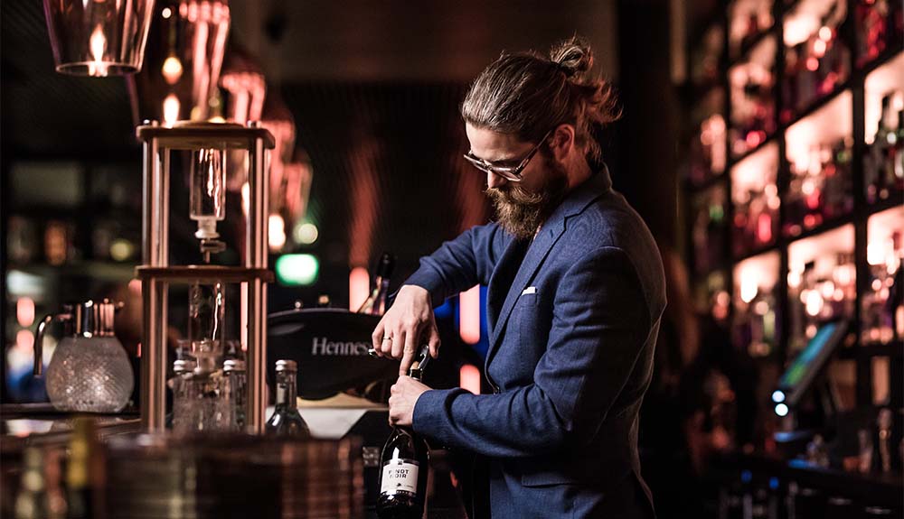 A server opens a bottle of wine at Golvet