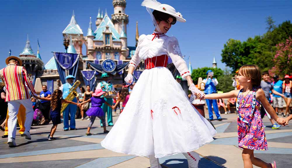 A child holds hands with a woman dressed as Mary Poppins at Disney World in Orlando