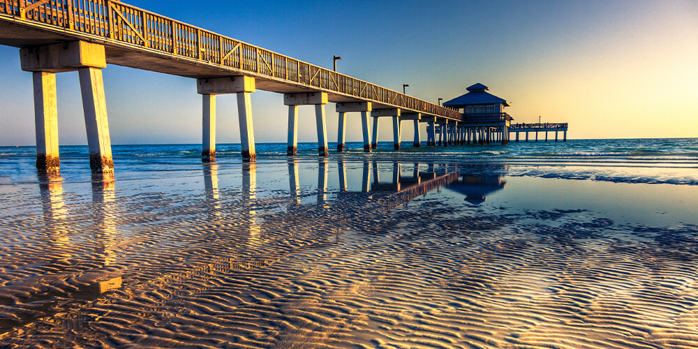 A long pier juts over the water in Florida